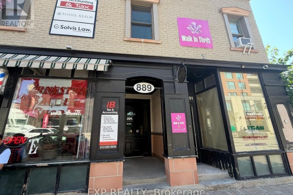 Close-up of the storefronts at 889 Bank Street, showing the entrances and signs for businesses. - B - 889 Bank Street, Ottawa