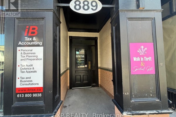 Detailed view of the main entrance at 889 Bank Street, featuring signage for 'iB Tax & Accounting' and 'Walk In Thrift'. - B - 889 Bank Street, Ottawa