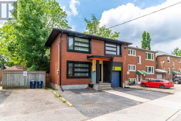 Exterior of a red brick duplex with modern black windows and an attached garage. - B - 9 York Street, Kitchener