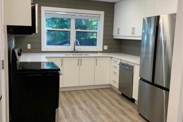 Kitchen with white cabinets, quartz countertops, stainless steel appliances, and a window. - B - 9 York Street, Kitchener