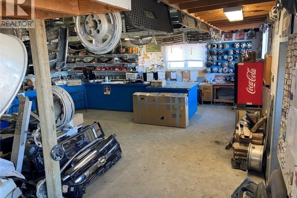 Another interior view of the parts shop showing grilles, tires, and a Coca-Cola vending machine. - B & G Wreckers, Brokenshell Rm No  68