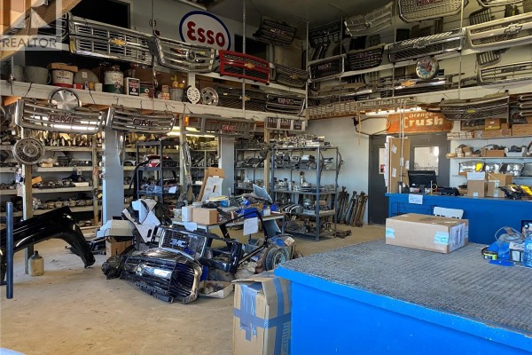 Interior of auto parts store displaying many chrome car grilles, shelves of parts, and signage. - B & G Wreckers, Brokenshell Rm No  68
