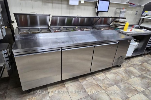 Stainless steel prep table with toppings containers and storage below - B-1 - 535 Saginaw Parkway, Cambridge