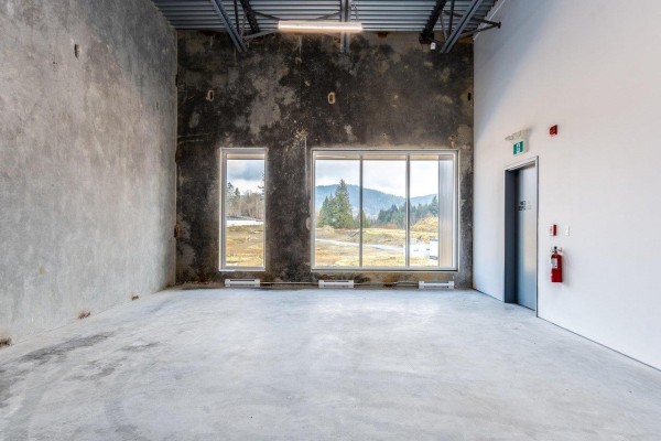 Commercial space with concrete floor, unfinished wall, large windows with mountain view. - B14 8650 Dewdney Trunk Road, Mission
