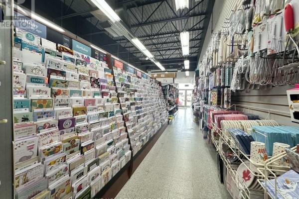 Interior of a retail store showing a white door, pegboard walls, and cleaning supplies. - B2 - 2537 Hamilton Regional Road 56, Hamilton