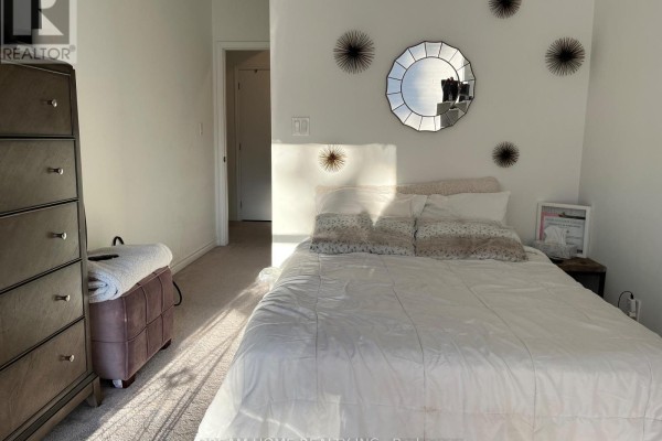 Bedroom with a queen-size bed, white bedding, and dresser. - B2 - 3 Falaise Road, Toronto