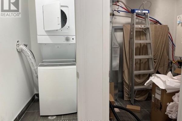 Laundry room with a stacked washer and dryer and storage items. - B2 - 3 Falaise Road, Toronto
