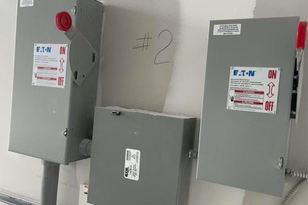 Electrical panels mounted on wall with labels and switches - B2 - 3101 Kennedy Road, Toronto