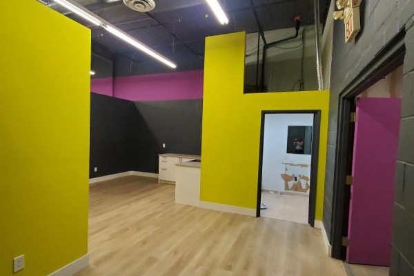 Interior view of commercial space with lime green wall and doorway. - B2 - 39 Orfus Road, Toronto