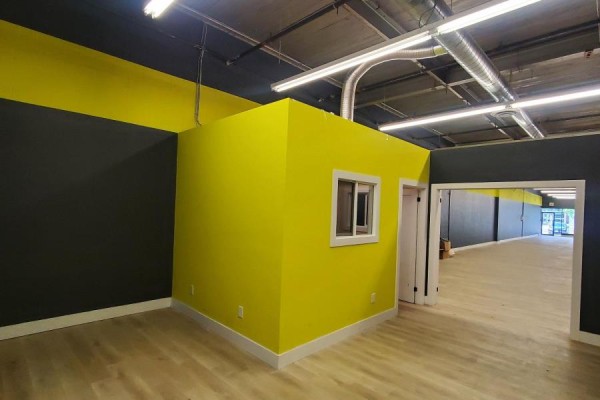 Interior commercial space with bright lime green wall and small window. - B2 - 39 Orfus Road, Toronto