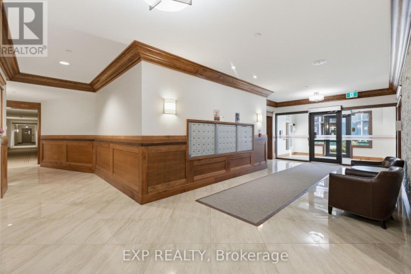 Lobby area with wooden accents, mailboxes, and seating, featuring tile flooring. - B409 - 258 Coleman Street, Carleton Place