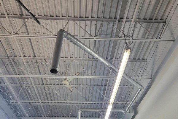 White metal ceiling with exposed trusses, ductwork, and lights. - B8 - 2370 Midland Avenue, Toronto