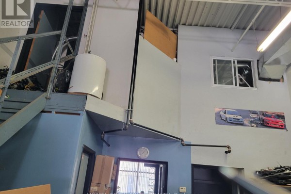Interior space with stairs, water heater, pipes, and a window. - B8 - 2370 Midland Avenue, Toronto