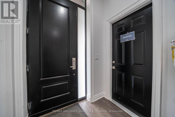 Interior view of two black doors, one with a frosted glass side panel. - Bachelor - 208 Dovercourt Road, Toronto