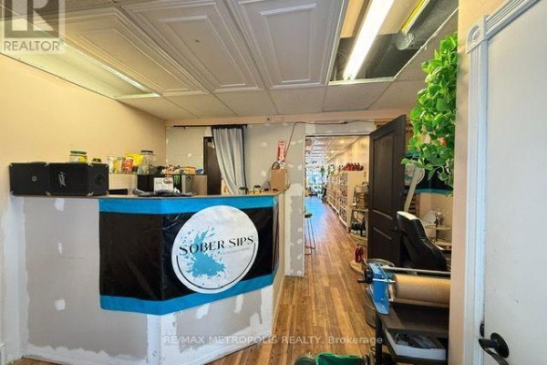 Interior view of a reception area with a counter and products on shelves. - Back - 15 Dunlop Street W, Barrie