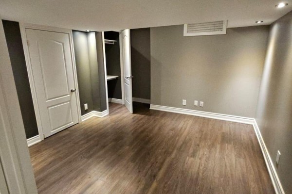 Basement bedroom with two doors, one open to a closet, and grey walls. - Basement - 118 Earlsbridge Boulevard, Brampton