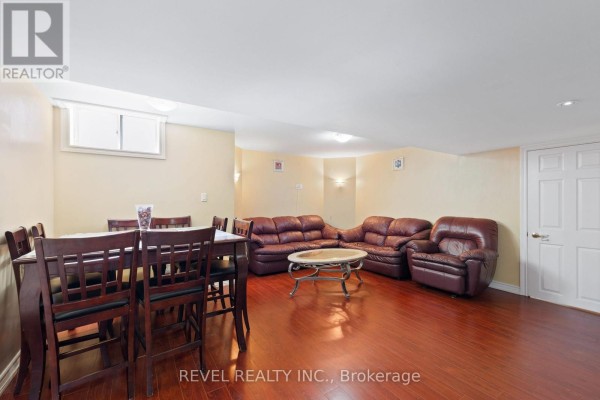 Basement living and dining area with a wooden dining table, leather sofas, and a marble coffee table. - Basement - 16 Terrance Drive, Markham