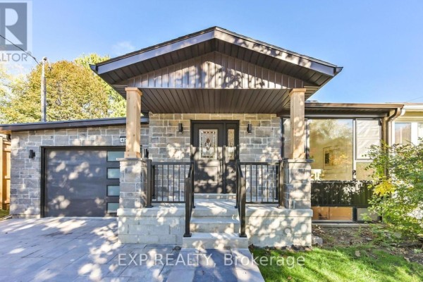 Exterior view featuring stone siding and paved driveway - Basement - 421 Browndale Crescent, Richmond Hill