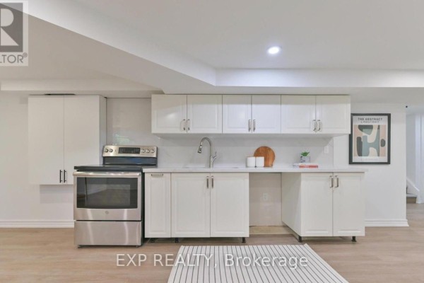 Kitchen with white cabinetry, stainless steel appliances, and quartz countertop - Basement - 421 Browndale Crescent, Richmond Hill