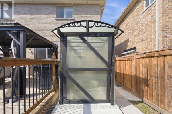 A small metal and plastic structure with a door on a paved patio. - Basement - 5 Watson Drive, New Tecumseth