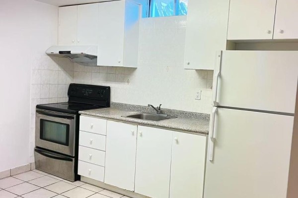Basement bedroom with mattress on a box spring and a wooden dresser. - Basement A2 - 50 Dowling Circle, Markham