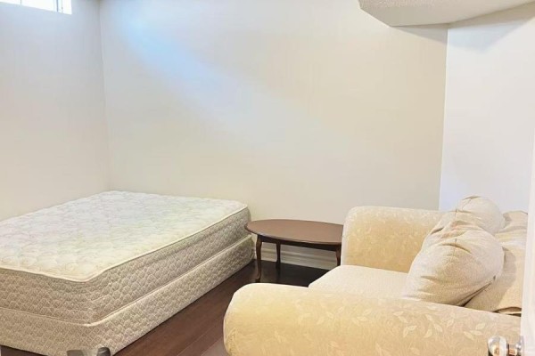 Basement bathroom with beige tiled shower-tub and toilet with roll of toilet paper. - Basement A2 - 50 Dowling Circle, Markham