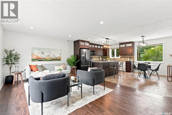 Open concept living area with kitchen, dining, and lounge spaces. - Bellavance Acreage, North Battleford Rm No  437