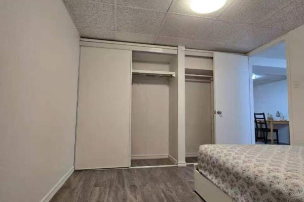 Small white kitchen with stainless steel appliances, white cabinets, and a gray countertop. - Bsm 24 - 1500 Sandhurst Circle, Toronto