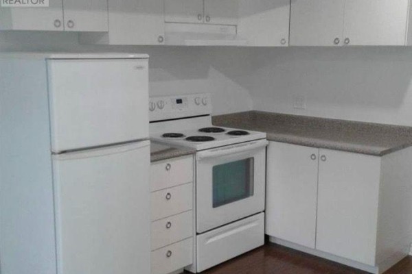 Kitchen with white cabinets, white stove, and white refrigerator. Grey speckled countertops and wood flooring are visible. - Bsmet - 75 Maffey Crescent, Richmond Hill