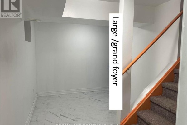 Empty basement area with white walls, marble-look flooring, and stairs. - Bsmt - 11 Seasons Drive, Toronto