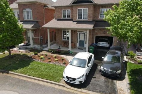 Aerial view of the house showing the front yard and driveway - Bsmnt - 33 George Robinson Drive, Brampton