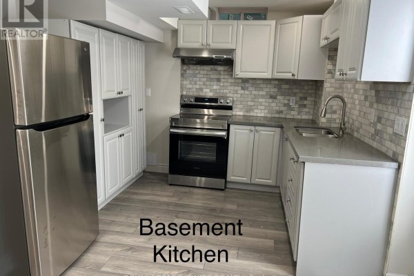 Basement kitchen with stainless steel appliances and light-colored cabinetry - Bsmnt - 33 George Robinson Drive, Brampton