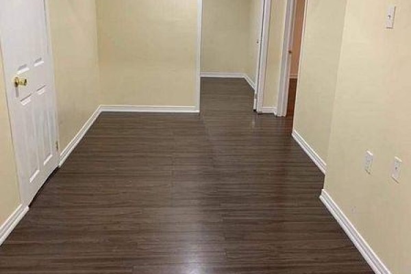 Hallway with dark wood laminate flooring, white trim, and cream walls. - Bsmt - 1 Royal Gala Crescent, Richmond Hill
