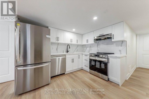 Bright white basement kitchen with stainless steel appliances, quartz countertops, and a black faucet. - Bsmt - 1006 Pelican Trail, Pickering