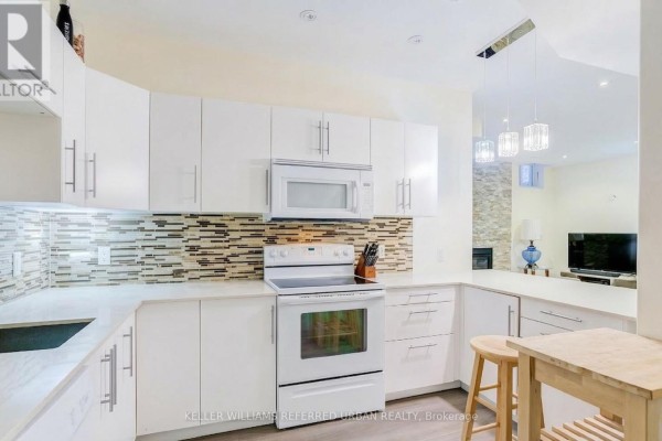 L-shaped kitchen layout with stainless steel appliances and mosaic backsplash - Bsmt - 161 Vanda Drive, Vaughan