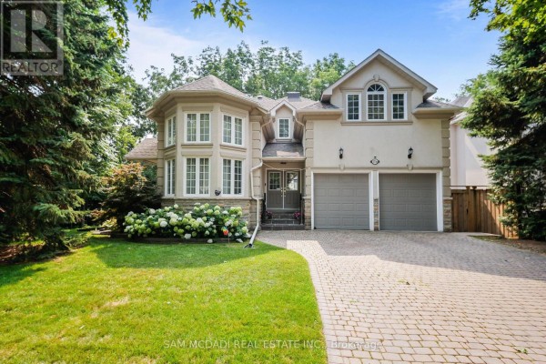 Front exterior of a two-story house with a manicured lawn, stone and stucco facade, and two-car garage. - Bsmt - 1770 Fellen Place, Mississauga