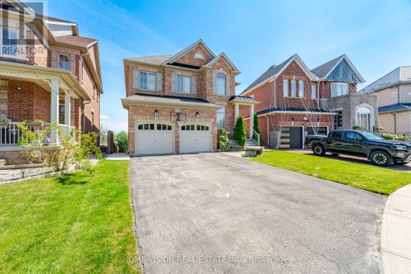 Driveway leading to a detached brick house with two garage doors and green lawn. - Bsmt - 18 Intrigue Trail, Brampton