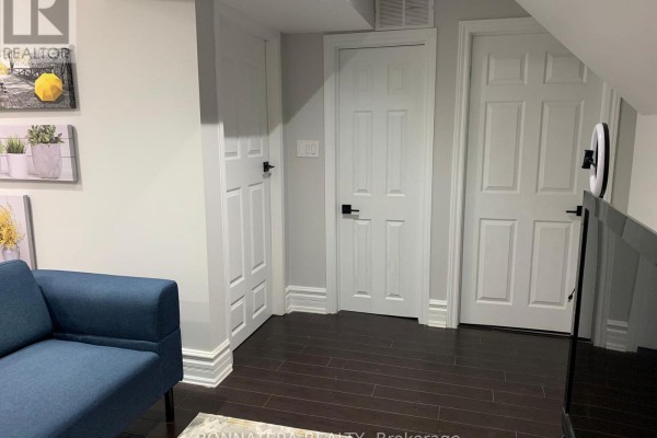 Hallway with three closed white doors with black hardware against grey walls. - Bsmt - 284 Hickory Circle, Oakville