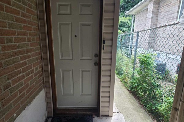Entrance door with a view of the side pathway and chain-link fence. - Bsmt - 285 Fiona Terrace, Mississauga