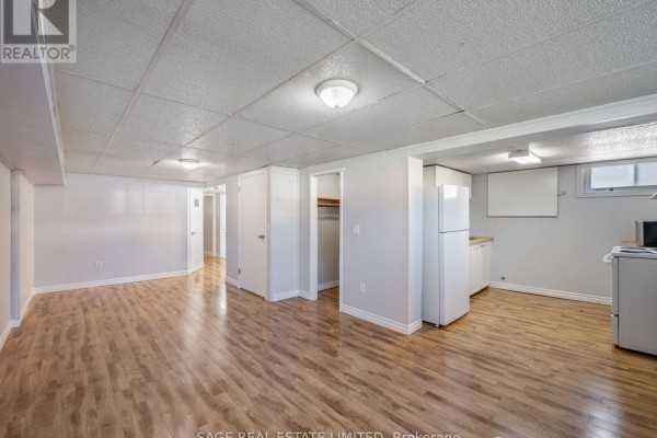 Small kitchen with white appliances, cabinets, wooden countertops, and wood floors. - Bsmt - 308 Taylor Mills Drive N, Richmond Hill