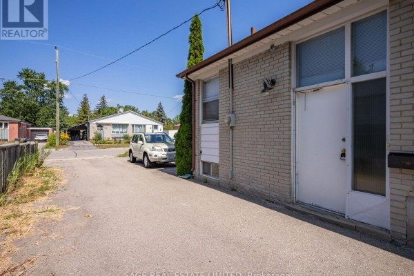 Basement kitchen with white appliances, light grey walls, and a window. - Bsmt - 308 Taylor Mills Drive N, Richmond Hill