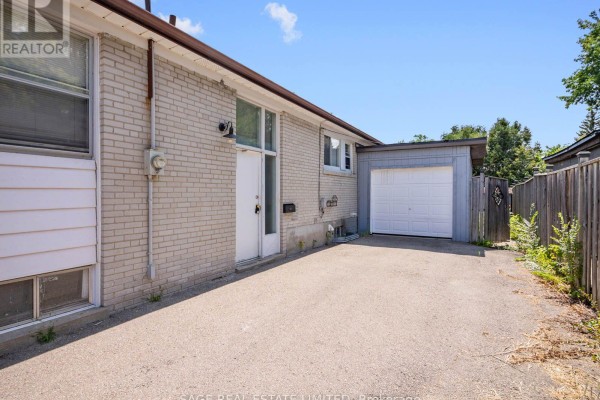 Empty basement room with wood laminate flooring, grey walls, and a small window. - Bsmt - 308 Taylor Mills Drive N, Richmond Hill