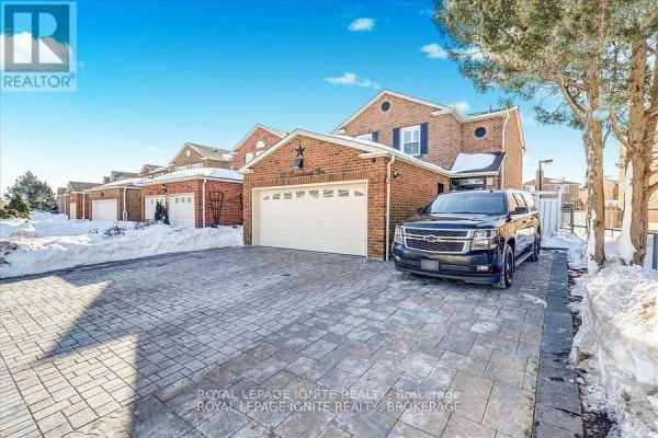 Side exterior view of a brick house showing a white door and adjacent paved walkway. - Bsmt - 32 Lansbury Drive, Toronto