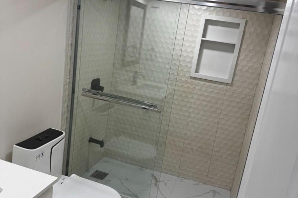 Bathroom with glass shower enclosure, tiled walls, and modern fixtures - Bsmt - 4029 Powderhorn Court, Mississauga