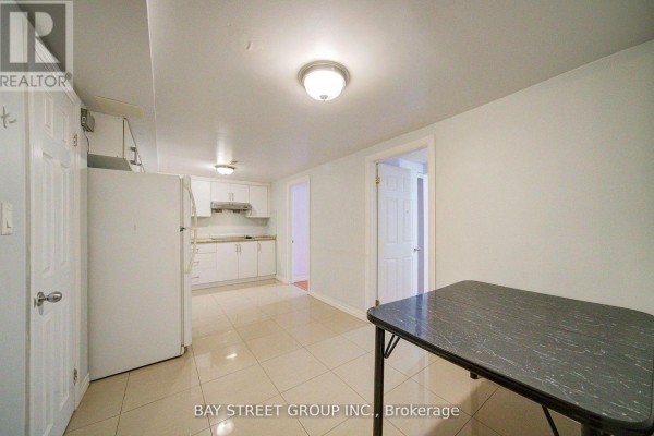 Hallway view with two doors, window, and laminate flooring - Bsmt - 5 Lockdare Street, Toronto
