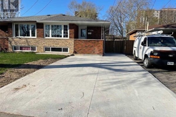 Extended view of a concrete driveway leading to a brick house with a parked white van. - #bsmt - 64 Gainsborough Road, Hamilton