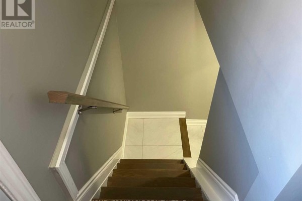 Wooden stairs with dark treads and a grey wall with a white handrail leading down. - #bsmt - 64 Gainsborough Road, Hamilton