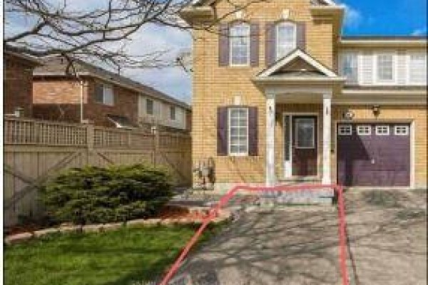 Driveway and lawn leading to the front entrance of a brick house. - Bsmt - 657 Thompson Road S, Milton