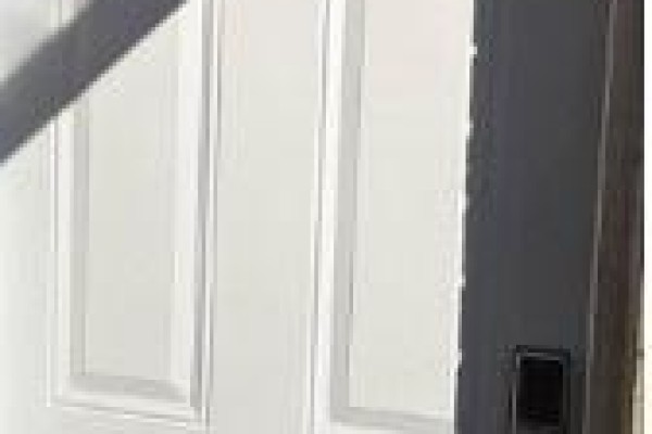 Close-up of a white panel door with a black door handle and lock. - Bsmt - 657 Thompson Road S, Milton