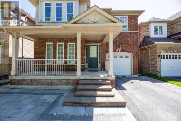 View of the front entrance with a teal door, covered porch with white railings, and a garage door. - Bsmt - 7 Vecchia Street, Markham